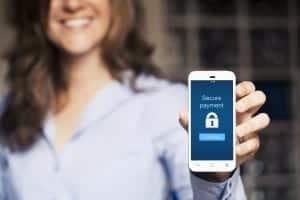 Secure payment message. Woman showing her mobile phone.